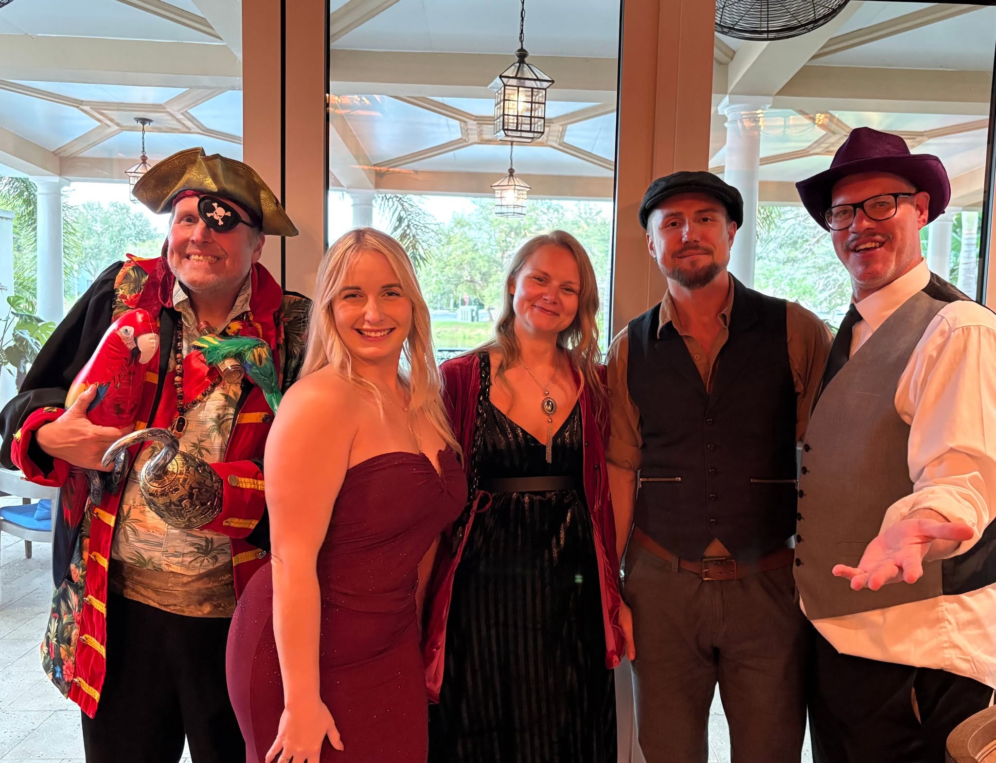 Riddlesbrood performers posing at Art Ovation Hotel in Sarasota, a stop on their Florida murder mystery tour.