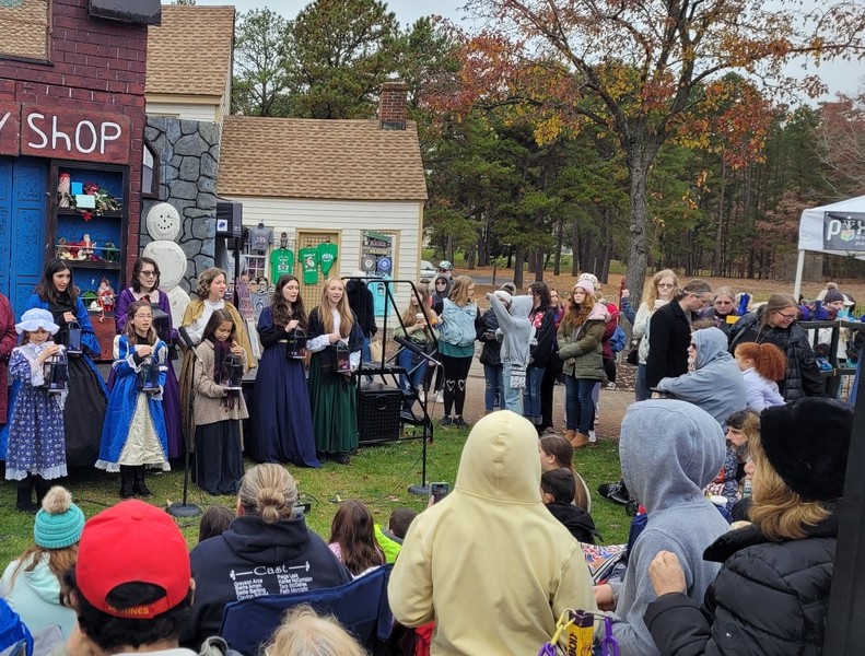 A vibrant NJ Festival with colorful decorations and an engaging performance taking place.
