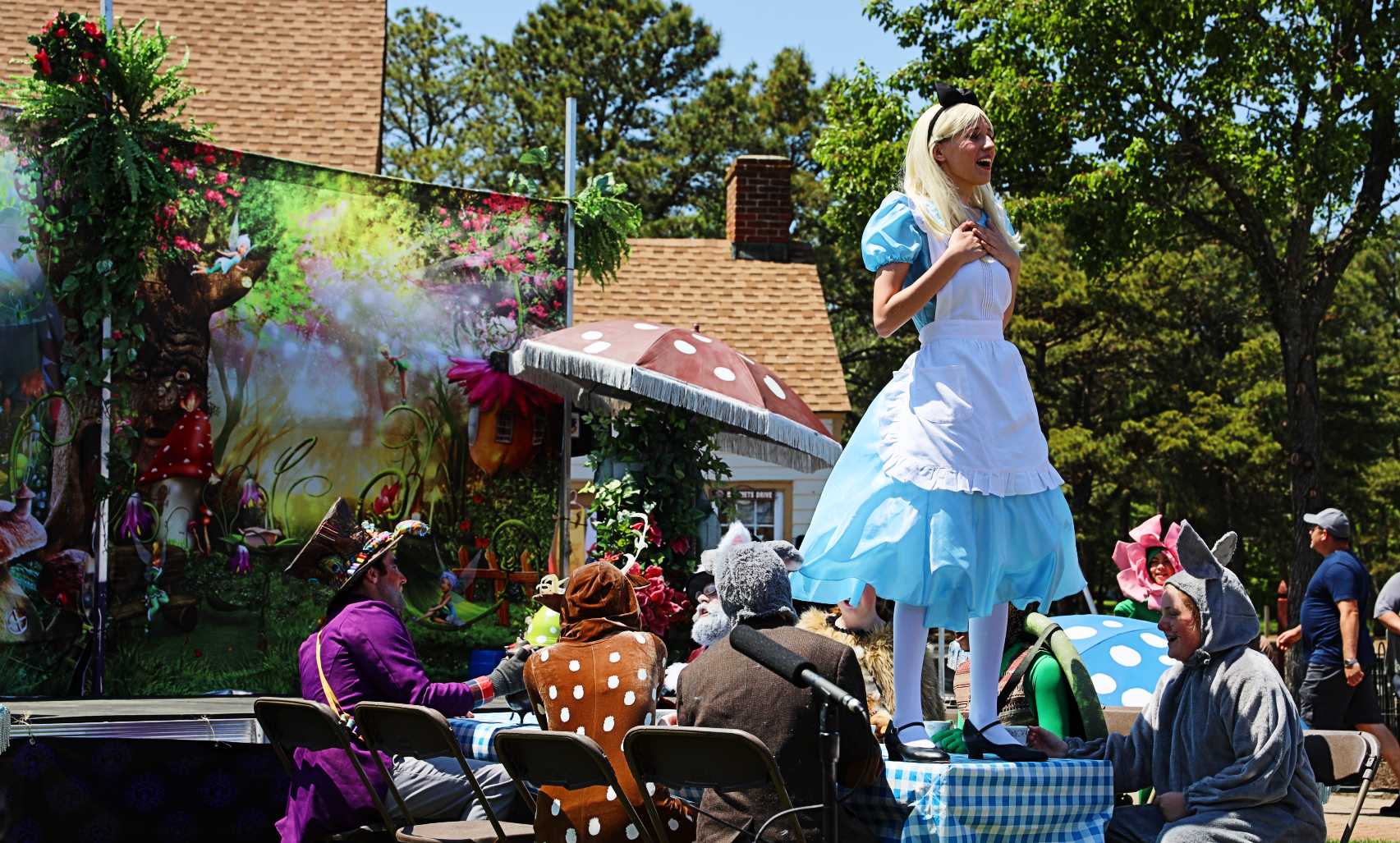 A lively scene from an NJ Festival, featuring an outdoor stage and a crowd enjoying the show.